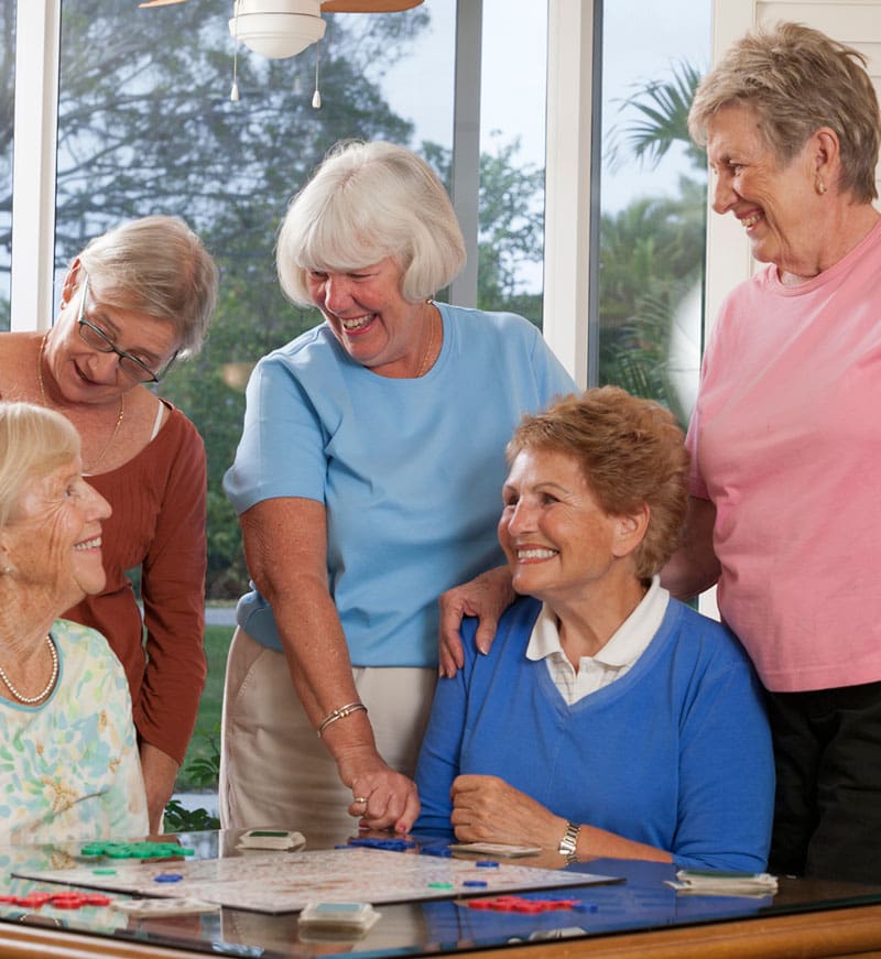 group of senior women playing a board game