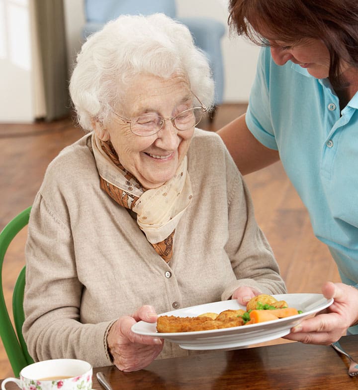 senior woman being served a meal